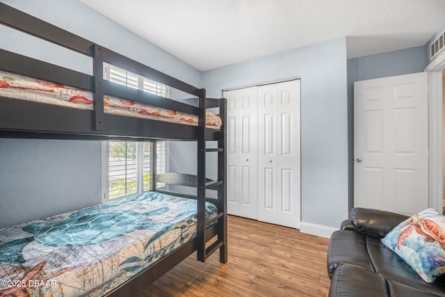 43 Pergola Pl, Ormond Beach, FL 32174 - bedroom with visible vents, baseboards, wood finished floors, and a closet