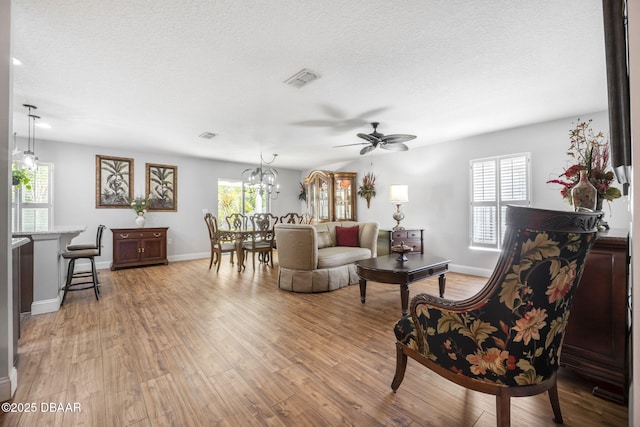 43 Pergola Pl, Ormond Beach, FL 32174 - living area with light wood-type flooring, baseboards, a textured ceiling, and ceiling fan