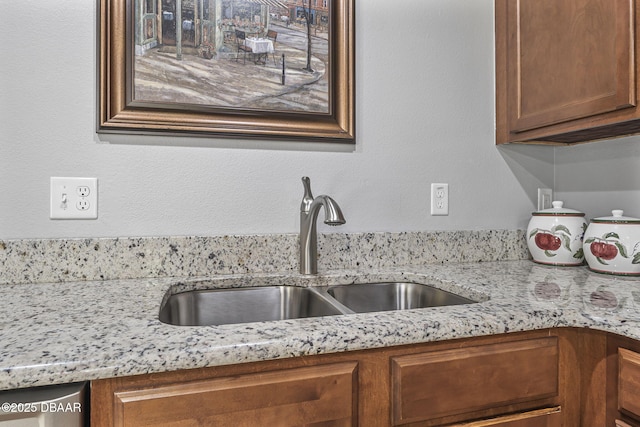 43 Pergola Pl, Ormond Beach, FL 32174 - kitchen with brown cabinetry, light stone counters, and a sink