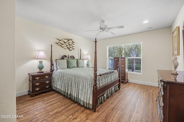 43 Pergola Pl, Ormond Beach, FL 32174 - bedroom with wood finished floors, a textured ceiling, a ceiling fan, and baseboards