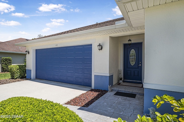 43 Pergola Pl, Ormond Beach, FL 32174 - doorway to property featuring a garage, concrete driveway, and stucco siding