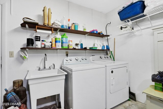 laundry room featuring washing machine and dryer and sink