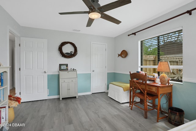 office space with ceiling fan and light hardwood / wood-style floors