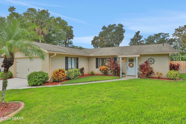 single story home featuring a garage and a front yard