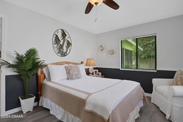 bedroom with dark hardwood / wood-style floors and ceiling fan