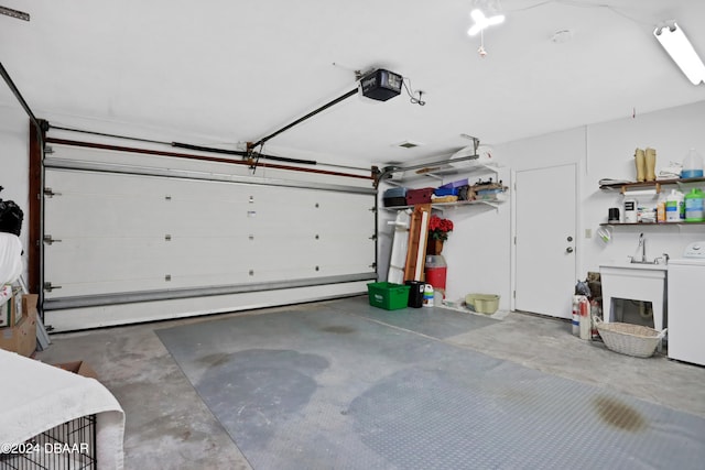 garage with washer / dryer and a garage door opener