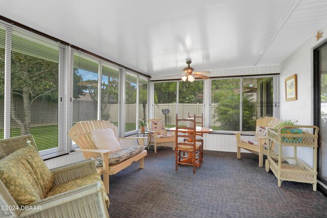 sunroom / solarium featuring ceiling fan