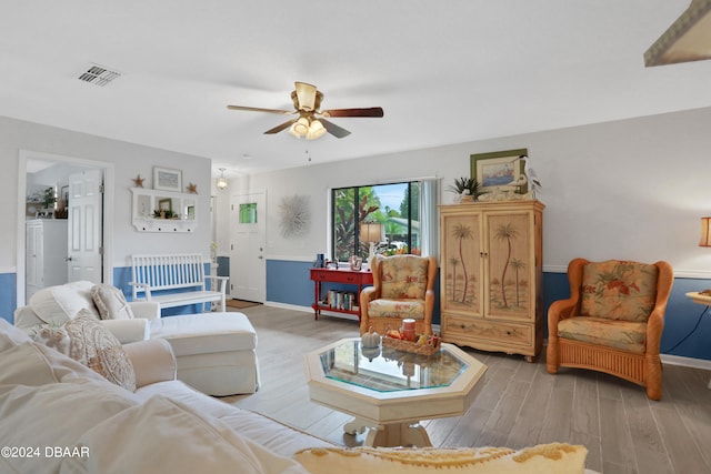 living room with ceiling fan and light hardwood / wood-style floors