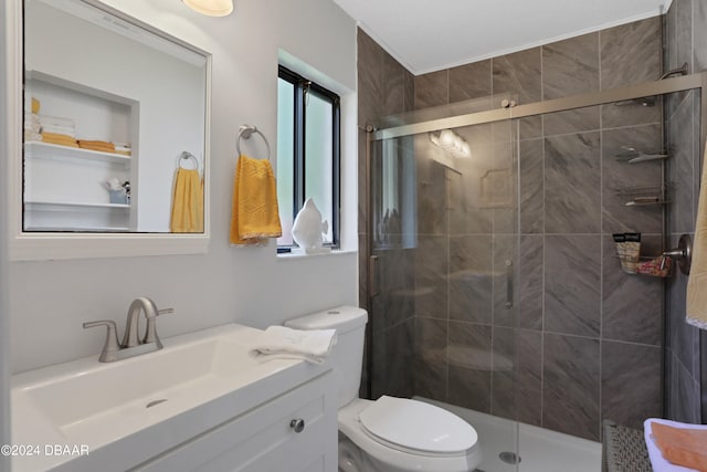 bathroom with vanity, toilet, and a shower with shower door