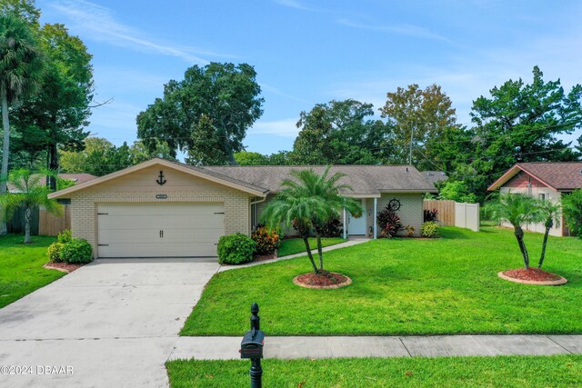 ranch-style home with a garage and a front lawn