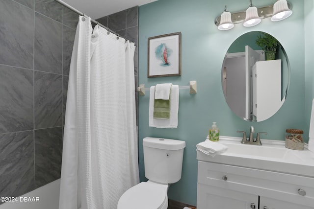 bathroom with curtained shower, vanity, and toilet