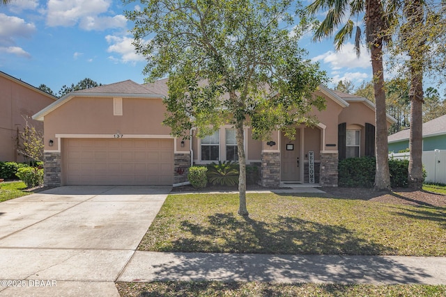 137 Boysenberry Ln, Daytona Beach, FL 32124 - view of front of home with stucco siding, stone siding, a garage, and concrete driveway