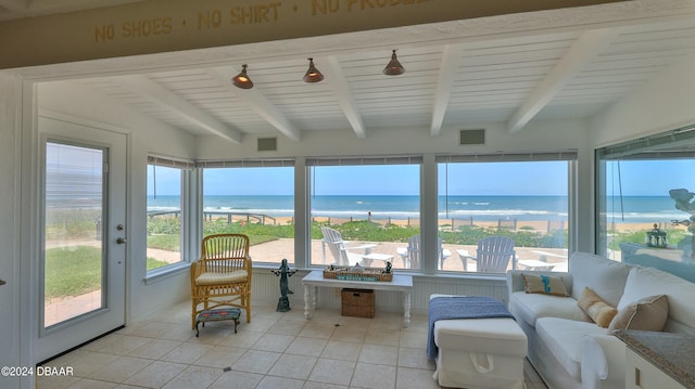 sunroom / solarium with beamed ceiling and a water view