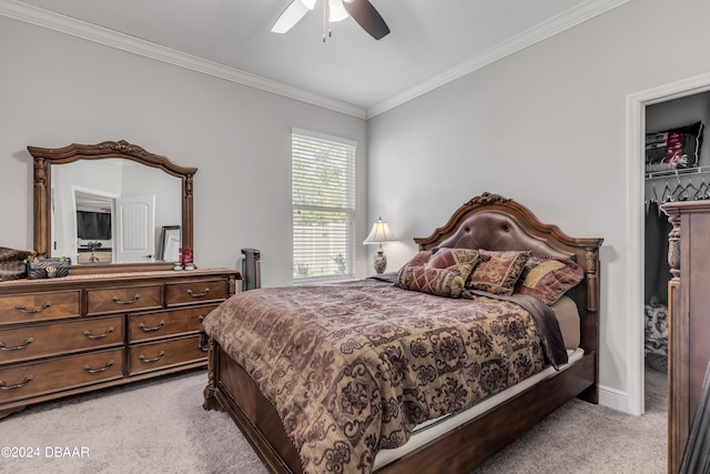 bedroom featuring a closet, light colored carpet, ceiling fan, and crown molding