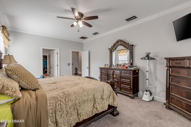 bedroom featuring ceiling fan, ornamental molding, and light colored carpet