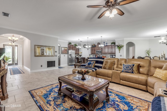 tiled living room with ceiling fan with notable chandelier and crown molding