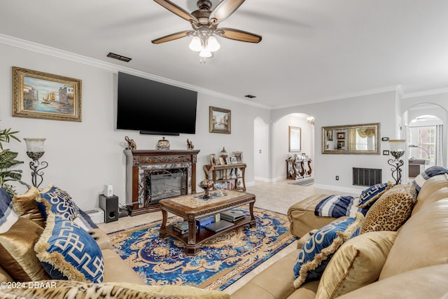 living room with ceiling fan, crown molding, and a high end fireplace