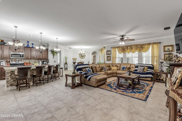 tiled living room featuring ceiling fan with notable chandelier and crown molding