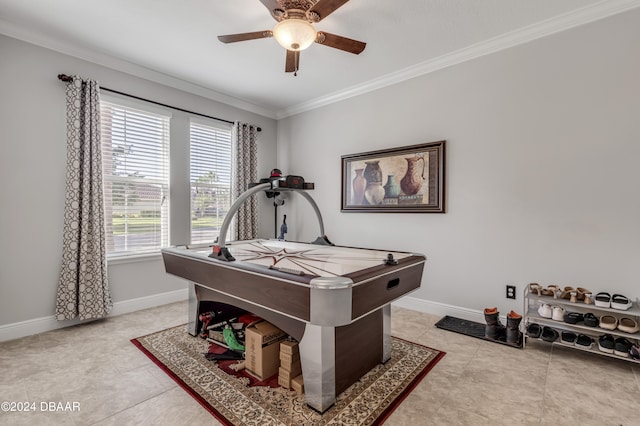 rec room featuring ceiling fan, light tile patterned floors, and crown molding