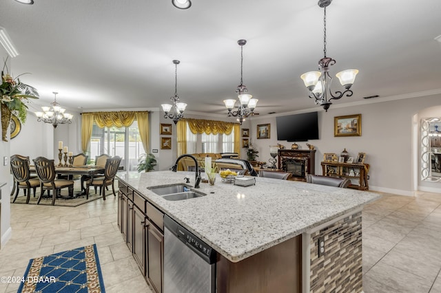 kitchen featuring crown molding, pendant lighting, sink, dishwasher, and a kitchen island with sink