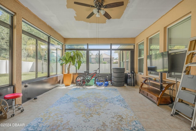 sunroom / solarium with ceiling fan and a healthy amount of sunlight