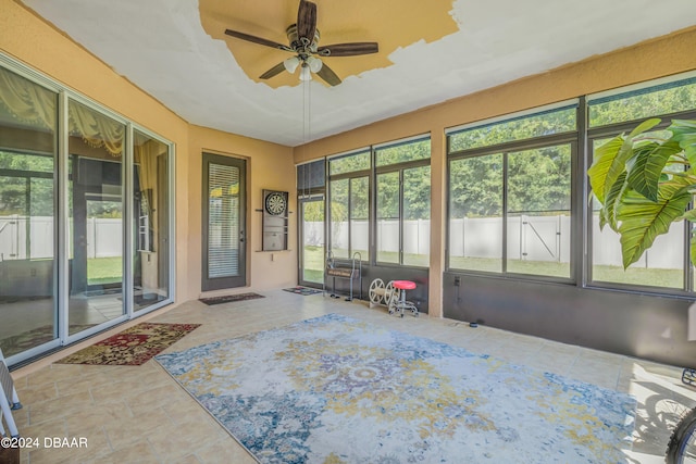 sunroom featuring ceiling fan