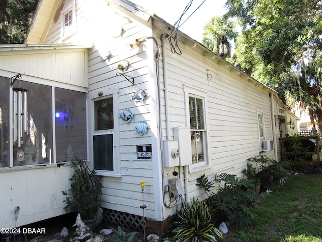 view of home's exterior featuring a sunroom and cooling unit