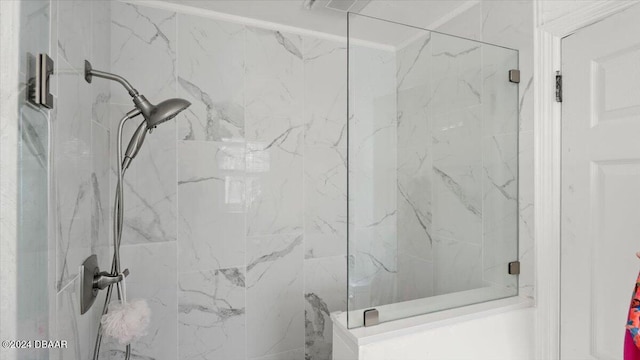 bathroom featuring a shower with shower door