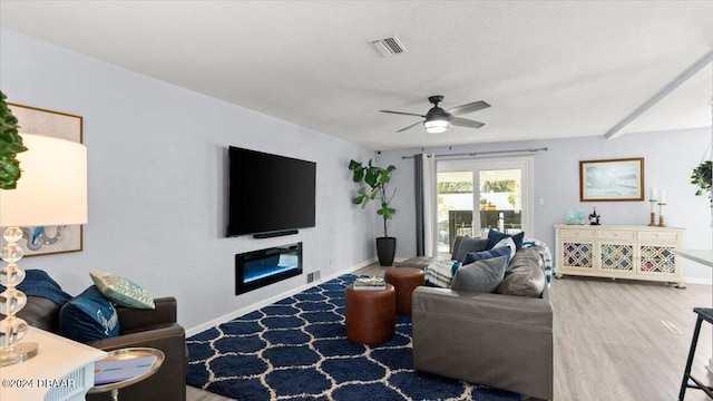 living room featuring ceiling fan and hardwood / wood-style flooring