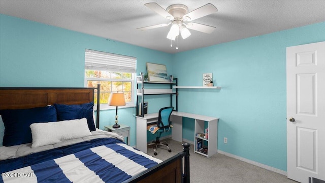 bedroom featuring carpet, a textured ceiling, and ceiling fan