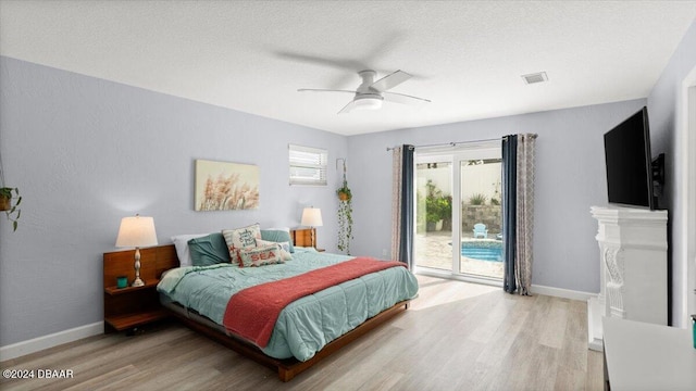 bedroom featuring access to exterior, ceiling fan, a textured ceiling, and hardwood / wood-style flooring