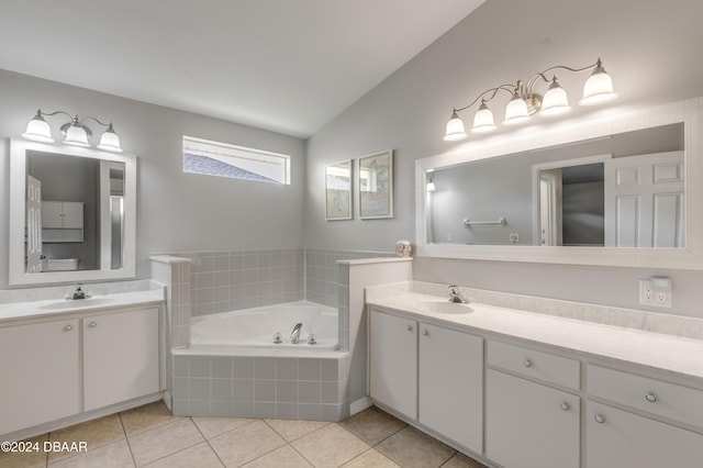 2853 Turnbull Estates Dr, New Smyrna Beach, FL 32168 - bathroom featuring tile patterned flooring, vanity, a relaxing tiled tub, and lofted ceiling