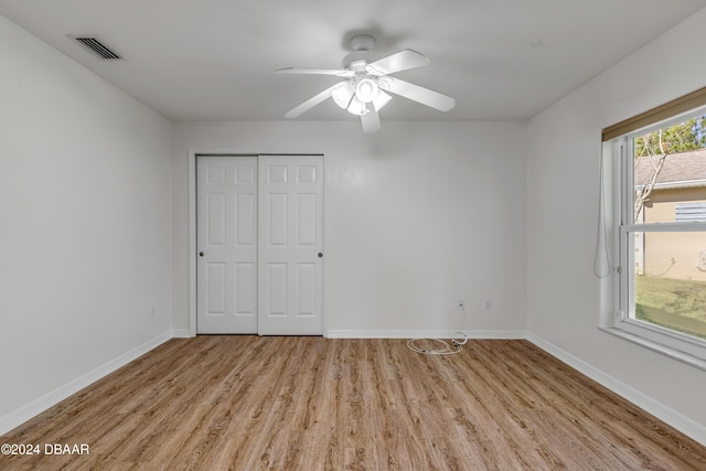 2853 Turnbull Estates Dr, New Smyrna Beach, FL 32168 - unfurnished bedroom featuring ceiling fan, a closet, and light hardwood / wood-style flooring