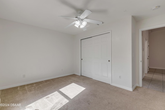 2853 Turnbull Estates Dr, New Smyrna Beach, FL 32168 - unfurnished bedroom with light carpet, a closet, and ceiling fan