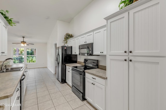 2853 Turnbull Estates Dr, New Smyrna Beach, FL 32168 - kitchen with sink, white cabinets, black appliances, and vaulted ceiling