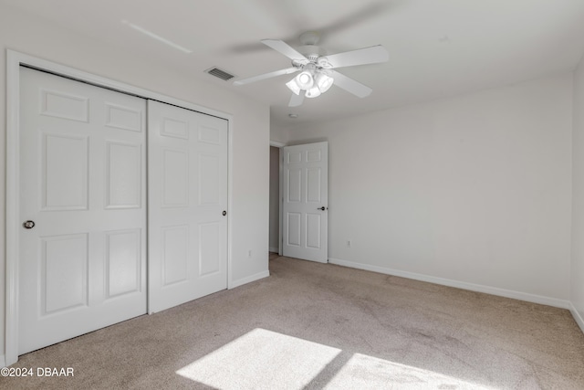 2853 Turnbull Estates Dr, New Smyrna Beach, FL 32168 - unfurnished bedroom with ceiling fan, light carpet, and a closet