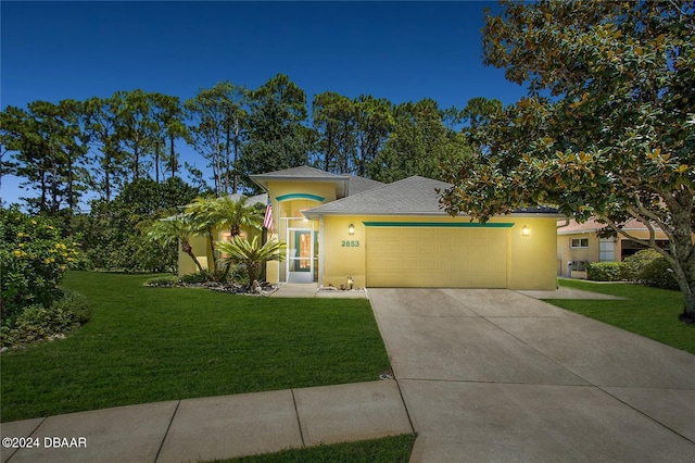 2853 Turnbull Estates Dr, New Smyrna Beach, FL 32168 - view of front of home with a yard and a garage