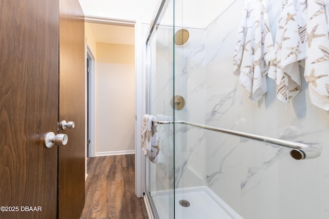 bathroom with hardwood / wood-style flooring and walk in shower