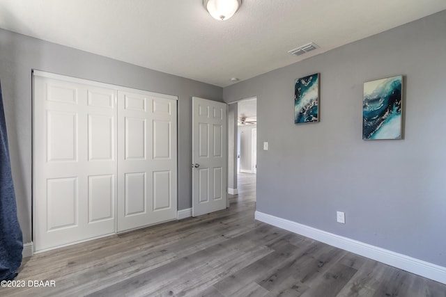 unfurnished bedroom with a closet, a textured ceiling, and light hardwood / wood-style flooring