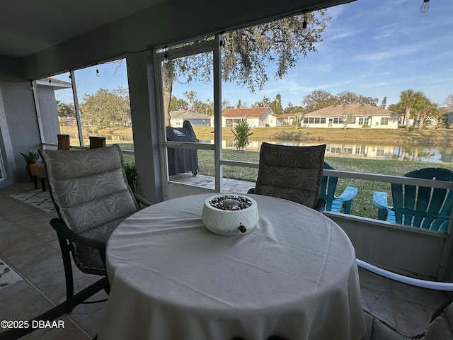 sunroom / solarium with a water view