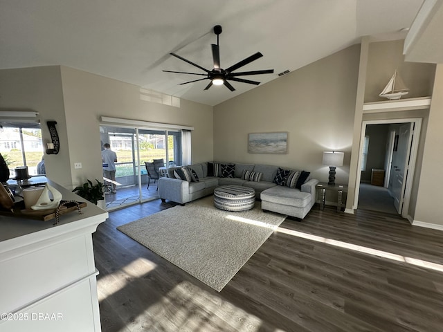 living room with plenty of natural light, high vaulted ceiling, dark hardwood / wood-style floors, and ceiling fan