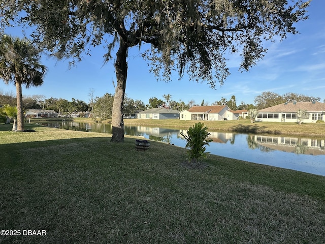 view of yard featuring a water view and a fire pit