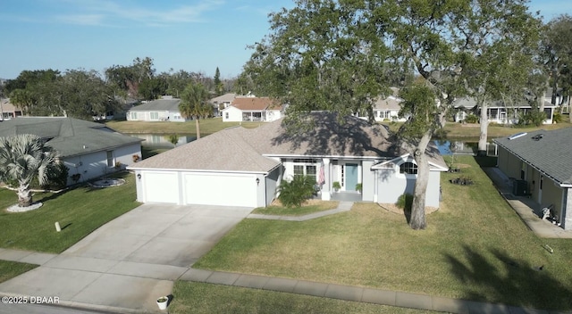 view of front facade with a water view, a garage, a front lawn, and cooling unit