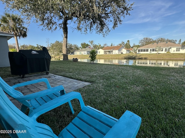 view of yard featuring a patio and a water view