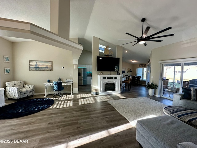 living room featuring dark wood-type flooring, ceiling fan, and high vaulted ceiling