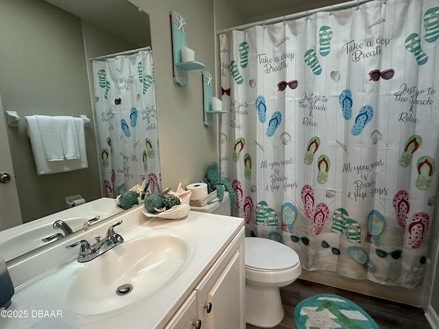 full bathroom with vanity, wood-type flooring, shower / tub combo, and toilet