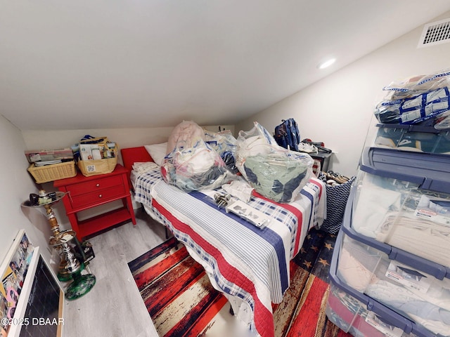 bedroom with lofted ceiling and hardwood / wood-style floors