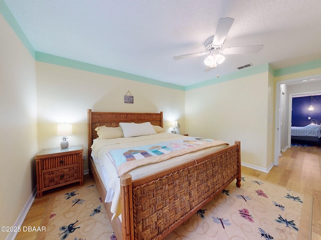 bedroom with ceiling fan and light hardwood / wood-style flooring