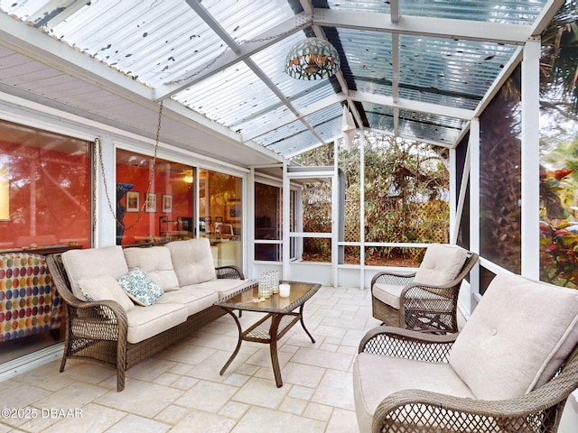 sunroom / solarium featuring lofted ceiling with beams