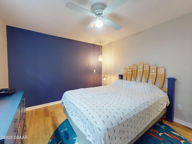 bedroom with ceiling fan and light wood-type flooring